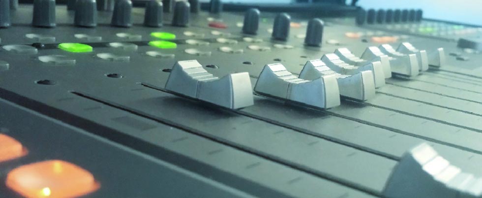 closeup of  faders of a DAW controller used for sound design and film mixing